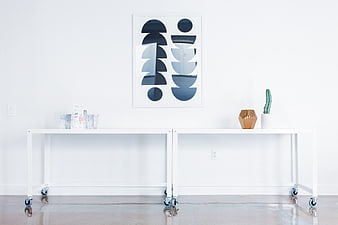 Minimalist white console table with abstract art and decor