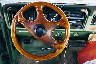 Vintage wooden steering wheel in classic green car interior