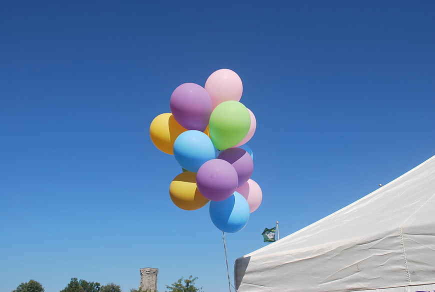 Colorful Pastel Balloons Floating Against Blue Sky