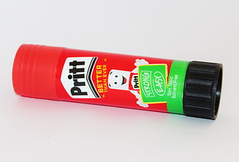 Red Pritt Glue Stick on White Background