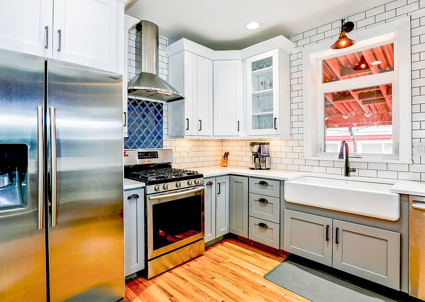 Modern kitchen with white cabinets, subway tile, and farmhouse sink