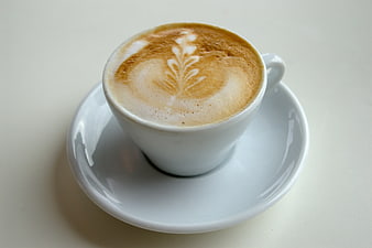 White Cup of Cappuccino with Latte Art on Saucer