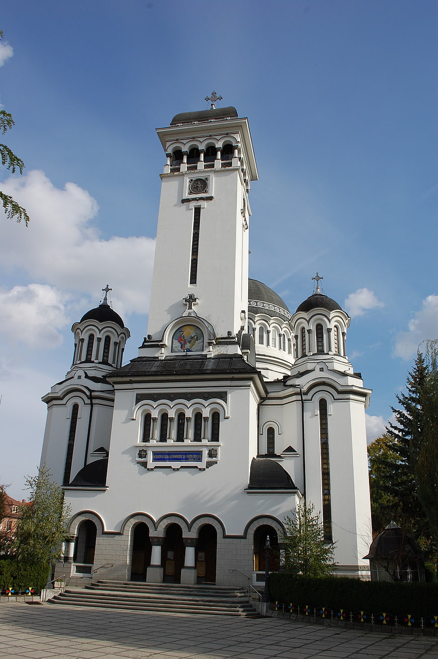 White Orthodox Church with Black Domes and Bell Tower