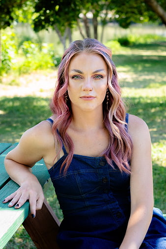 Portrait of Woman with Pink Hair Sitting on Park Bench