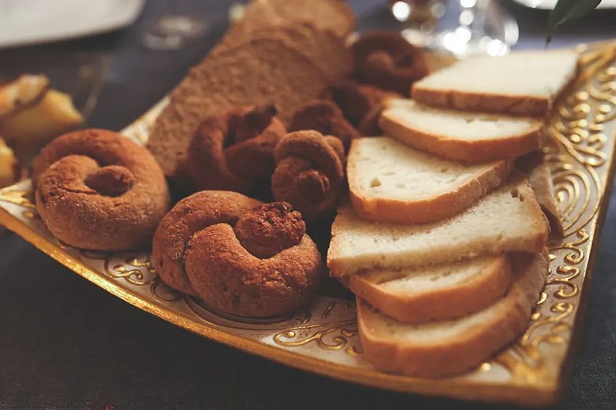 Assorted bread and pastries on ornate golden tray
