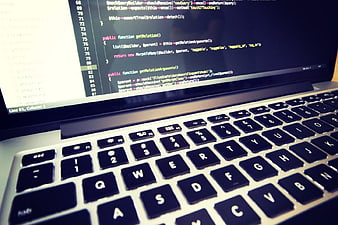 Close-up of PHP Code on Laptop Screen with Keyboard