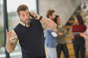 Concerned Businessman Talking on Phone in Modern Office