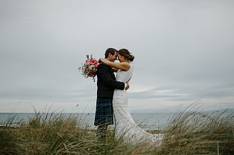 Scottish Wedding Couple Embracing on Coastal Dunes