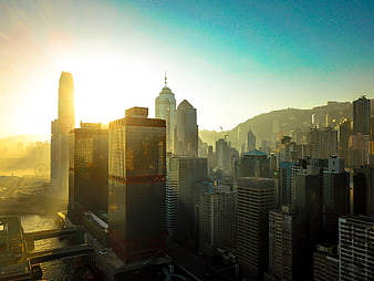 Golden Hour Hong Kong Skyline with Skyscrapers and Hazy Sun