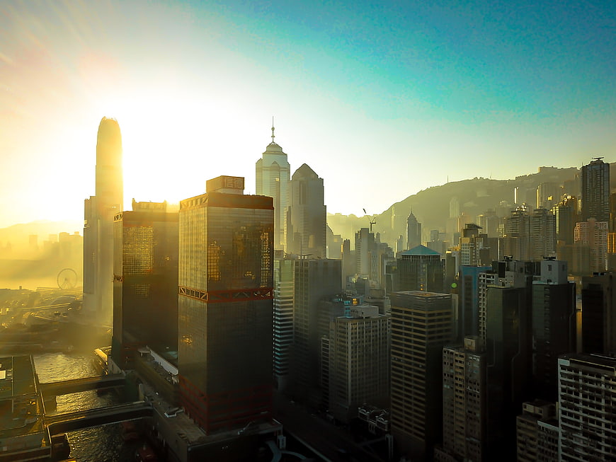 Golden Hour Hong Kong Skyline with Skyscrapers and Hazy Sun