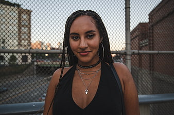 Portrait of smiling woman with braids in urban setting