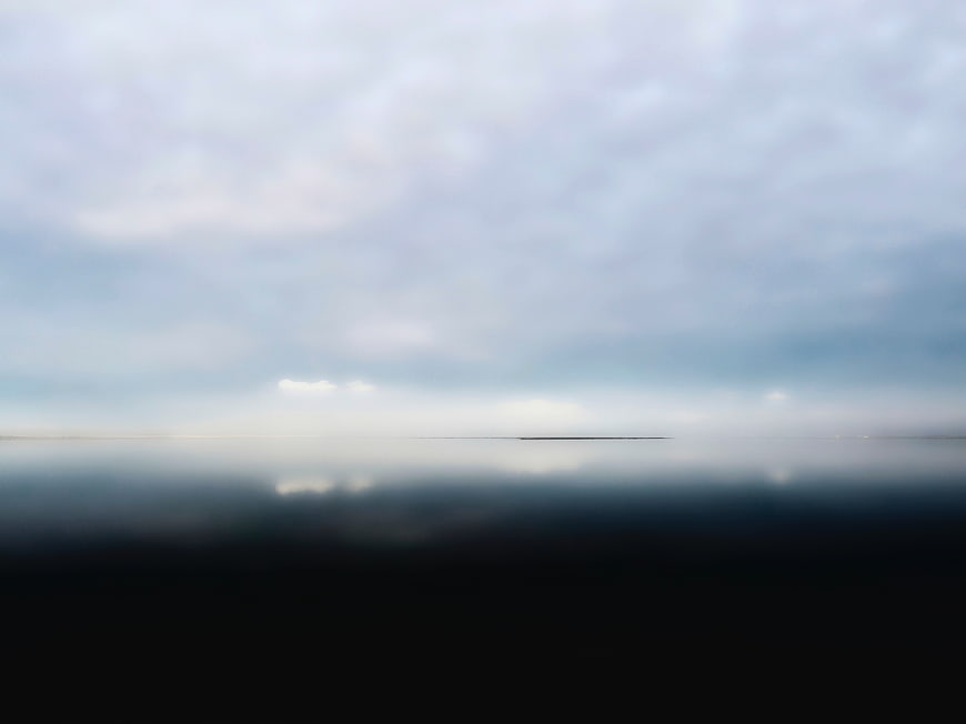Minimalist Misty Lake Landscape with Cloud Reflections