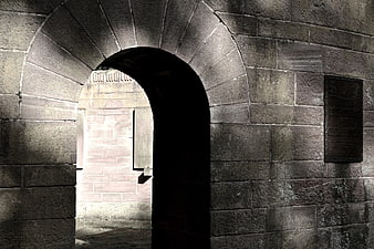 Dark Stone Archway with Plaque at Night