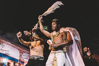 Men in Carnival Costumes Dancing at Night