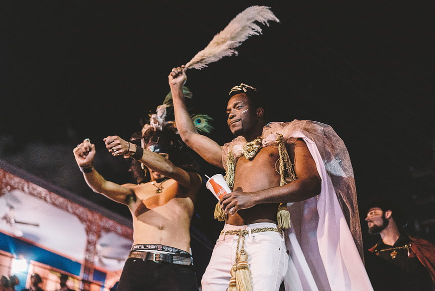 Men in Carnival Costumes Dancing at Night