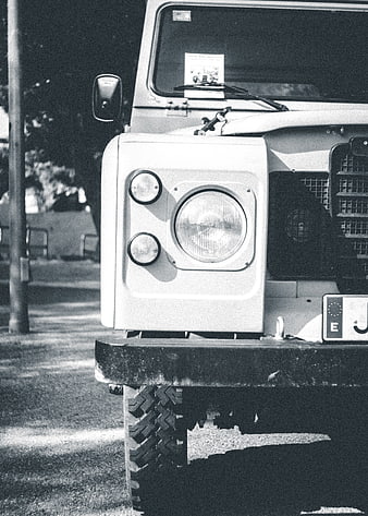 Close-up of vintage Land Rover Defender front headlight