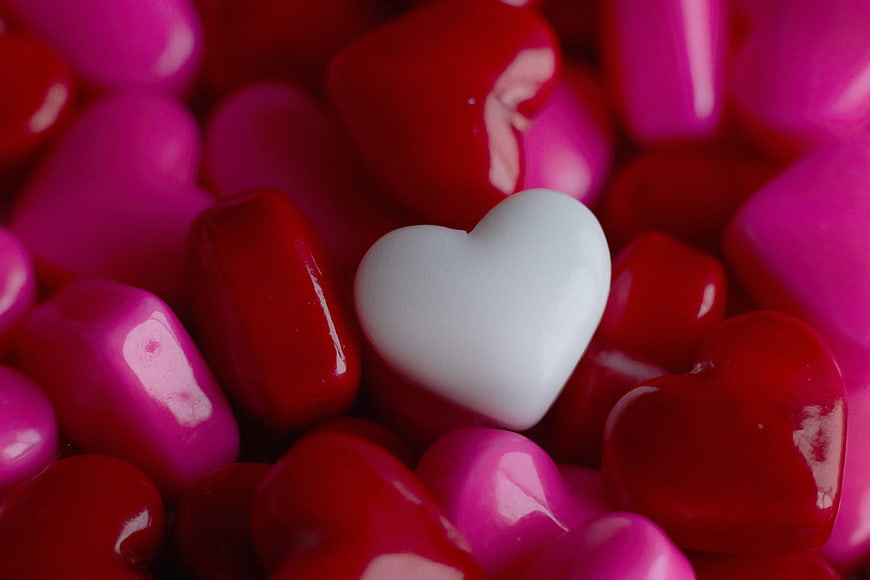 White Heart Candy Among Red and Pink Hearts