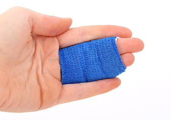 Hand with blue bandage on finger isolated on white background