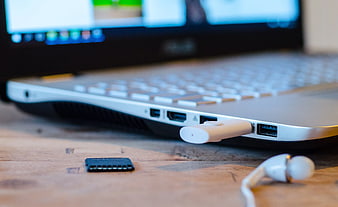 Close-up of laptop side ports with USB flash drive plugged in