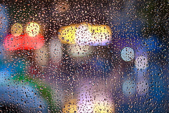 Raindrops on Glass with Colorful Bokeh Lights