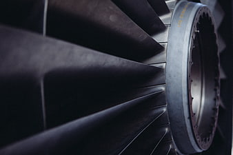 Close-up of dark metallic jet engine turbine blades