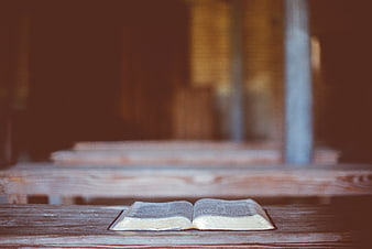 Open Bible on Wooden Bench in Church