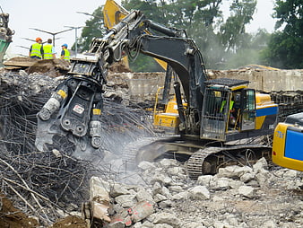 Heavy Excavator Demolishing Concrete Structure with Steel Rebar