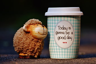 Cute Sheep Figurine Next to Coffee Cup with Positive Quote