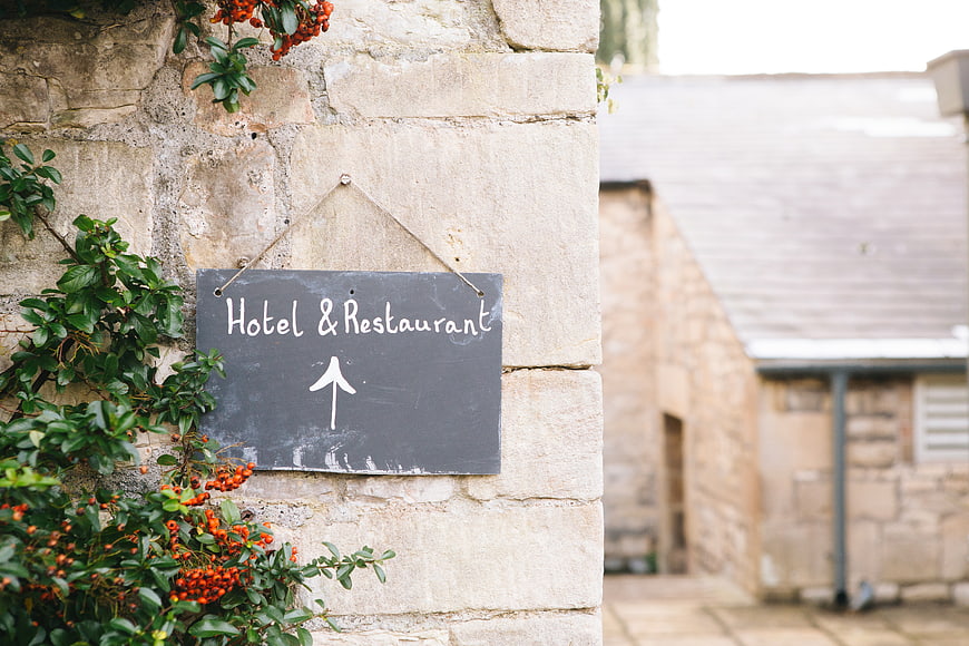Chalkboard Hotel Restaurant Sign on Stone Wall