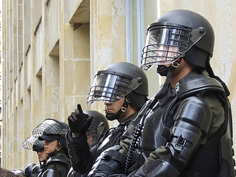 Riot Police Officers In Full Protective Gear Standing In Formation