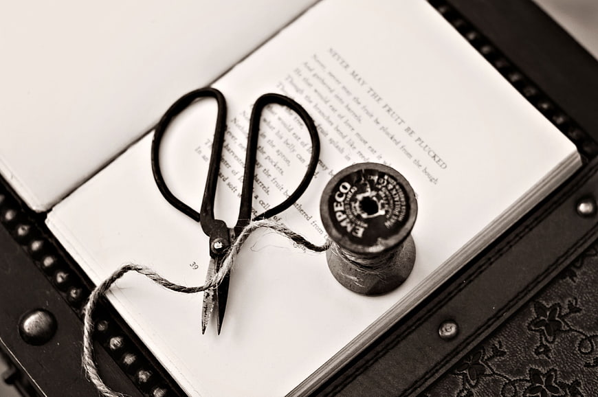 Vintage Scissors and Thread Spool on Open Book