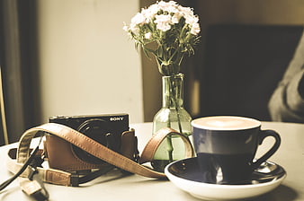 Vintage Camera, Coffee, and Flowers on Table