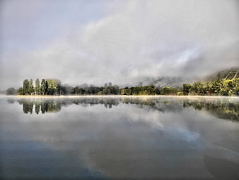 Serene Misty Lake Landscape with Tree Reflections