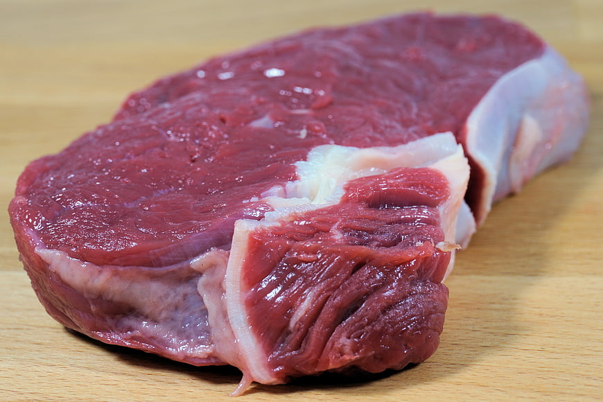 Fresh Raw Beef Steak on Wooden Cutting Board