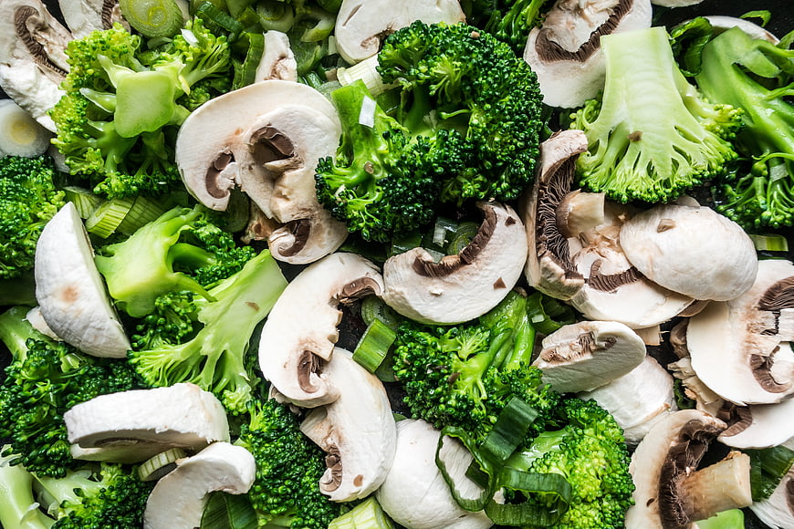 Fresh Sliced Mushrooms and Broccoli Florets Close-Up