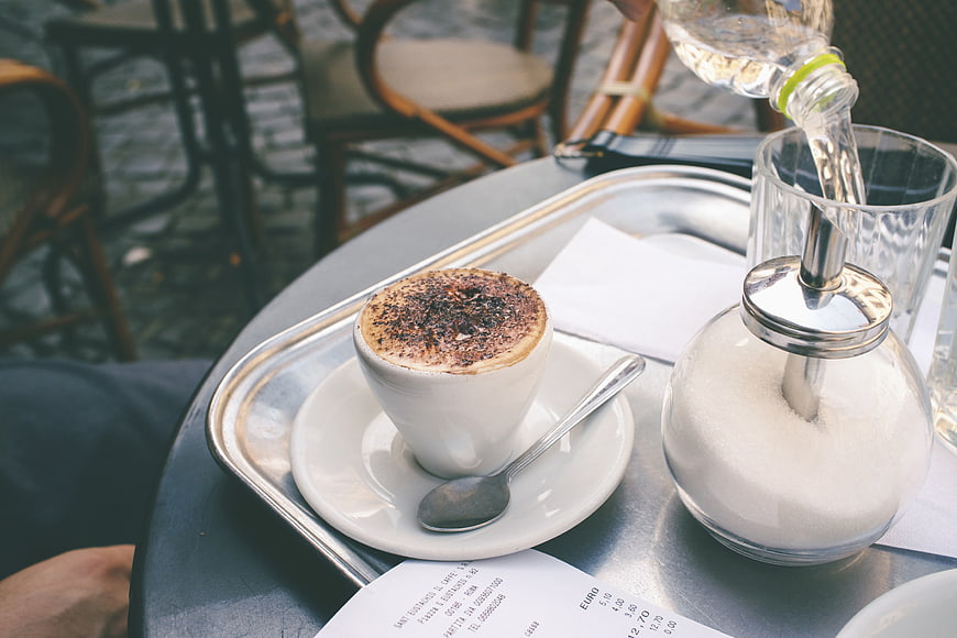 Cappuccino and Sugar at Outdoor Cafe Table