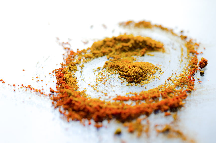 Spiral of mixed spices on white background