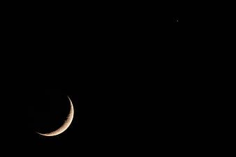 Crescent Moon in Dark Night Sky with Distant Star