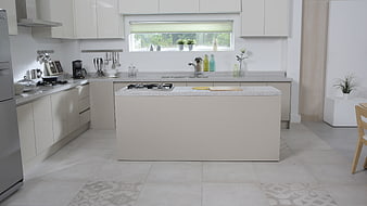 Modern white kitchen with central island and natural light