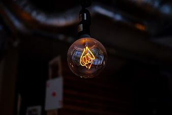 Glowing Vintage Edison Lightbulb in Dark Setting