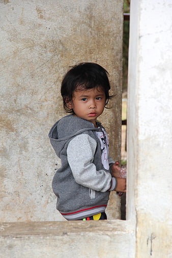 Portrait of a young child looking back from a doorway