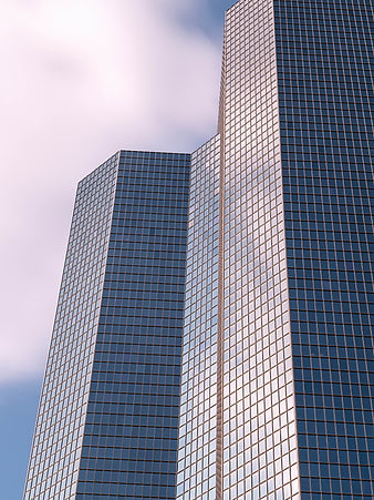 Modern Glass Skyscraper Architecture Against Blue Sky