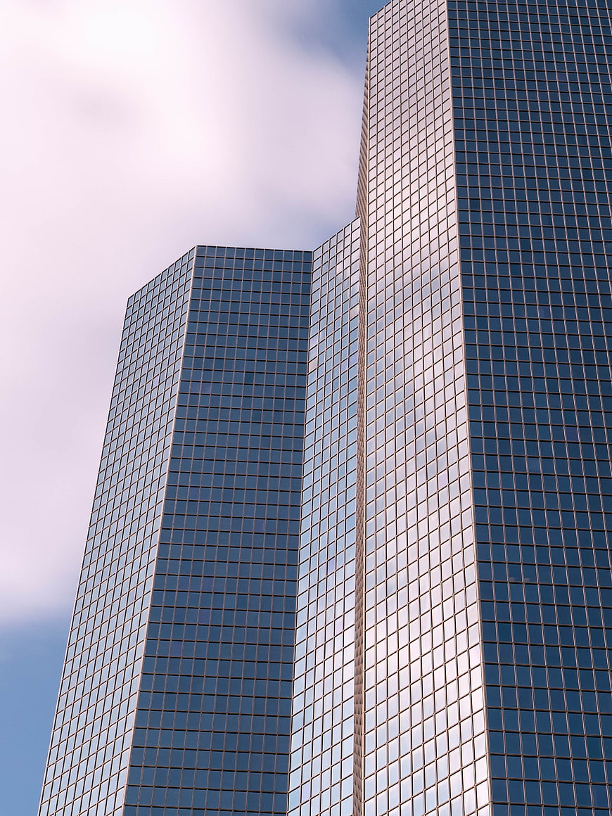 Modern Glass Skyscraper Architecture Against Blue Sky