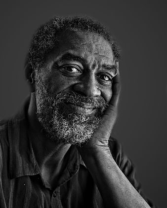 Black and white portrait of smiling elderly bearded man