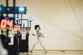 Fencer in Action with Scoreboard in Foreground