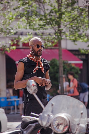 Stylish Black Man with Sunglasses and Scarf on Scooter