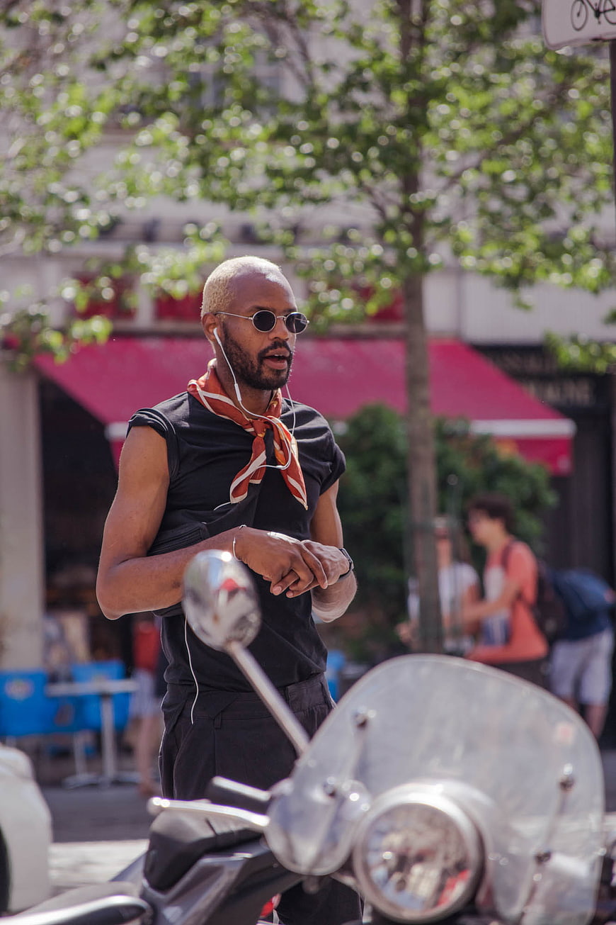 Stylish Black Man with Sunglasses and Scarf on Scooter