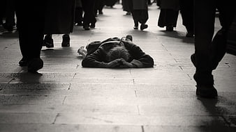 Prostrate Pilgrim Kneeling on Stone Street Amidst Crowds