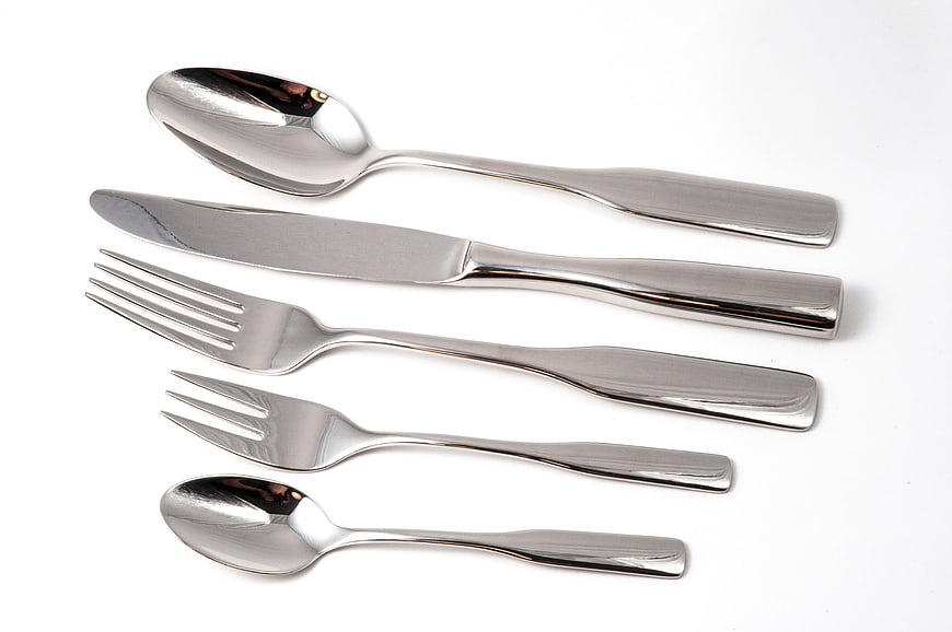 Silver Cutlery Set Arrangement On White Background