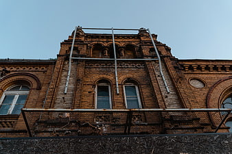 Low Angle View Of Weathered Brown Brick Building Facade